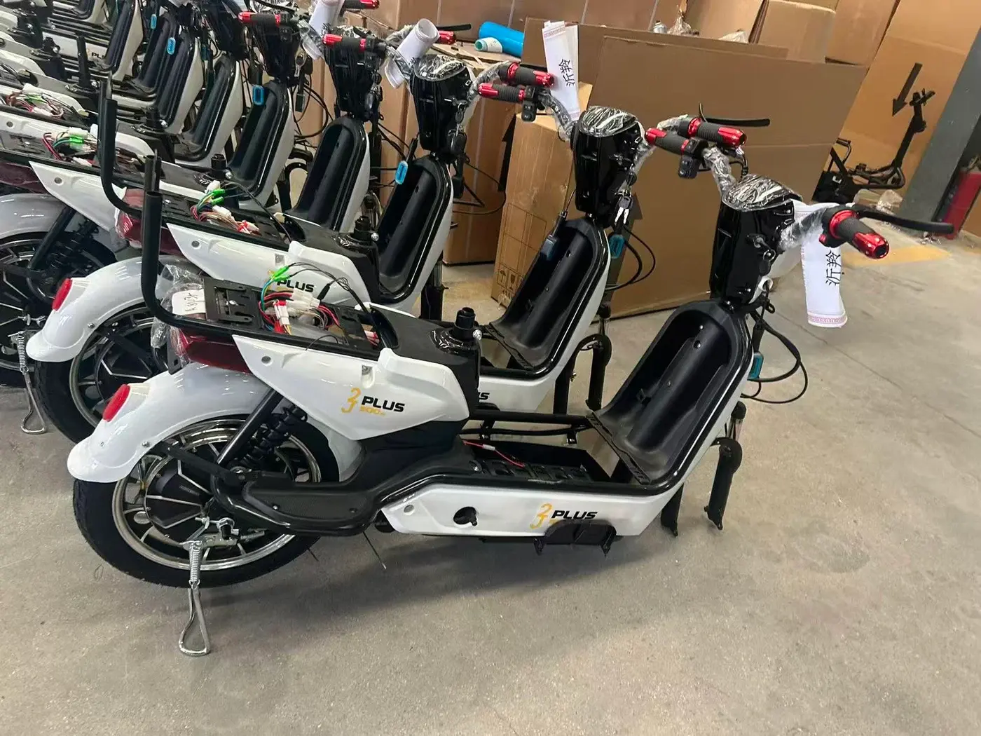 White Golden Eagle electric scooter during assembly, with seat and some parts not installed